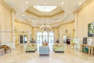 a living room with furniture and a chandelier