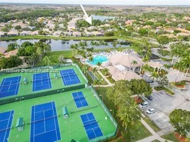 a view of a swimming pool with a patio and a yard