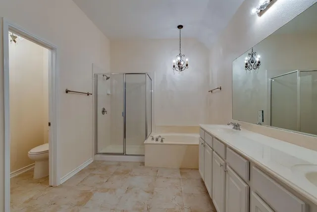 a spacious bathroom with a shower sink and a mirror