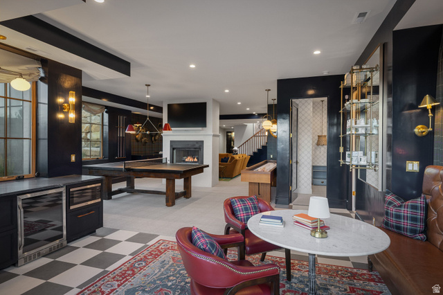 558 West Rheinfalls Circle Midway, UT 84049 - Photo 30 of 61 Sophisticated recreation space featuring a wood-finish pool table, built-in bar cabinetry with integrated beverage cooler, fireplace with surround shelving, checkered tile flooring, and recessed ceiling lighting