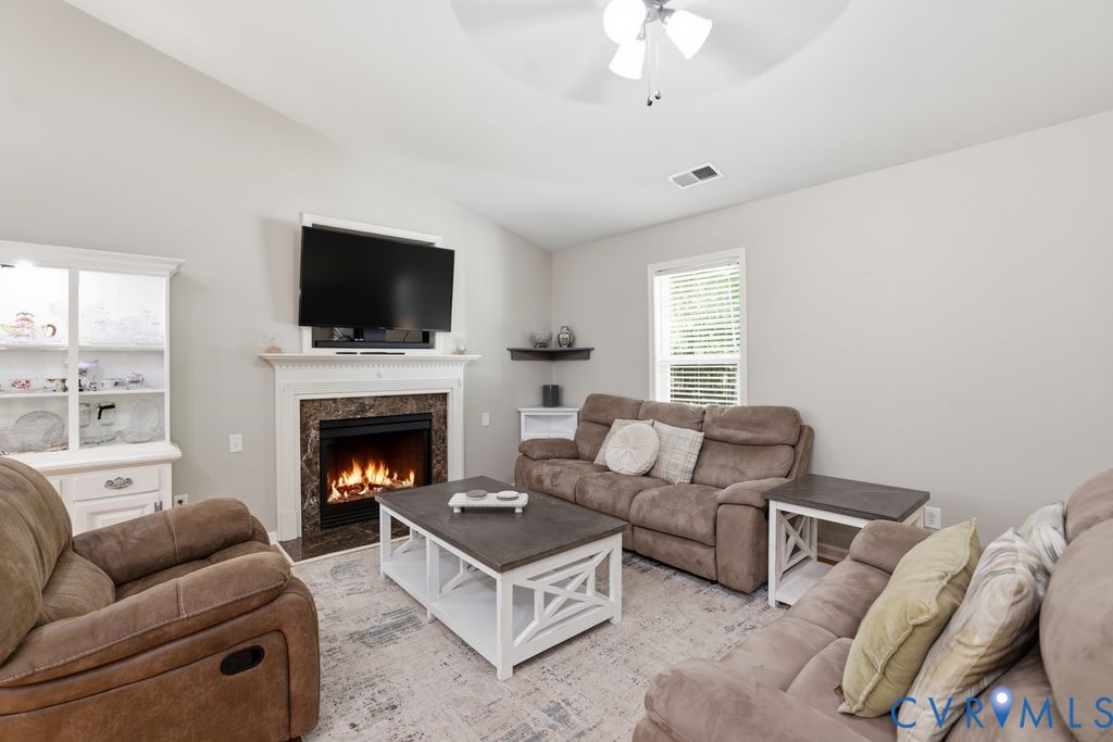 5307 St Pauls Church Road Goochland, VA 23063 - Photo 11 of 44 a living room with furniture a flat screen tv and a fireplace