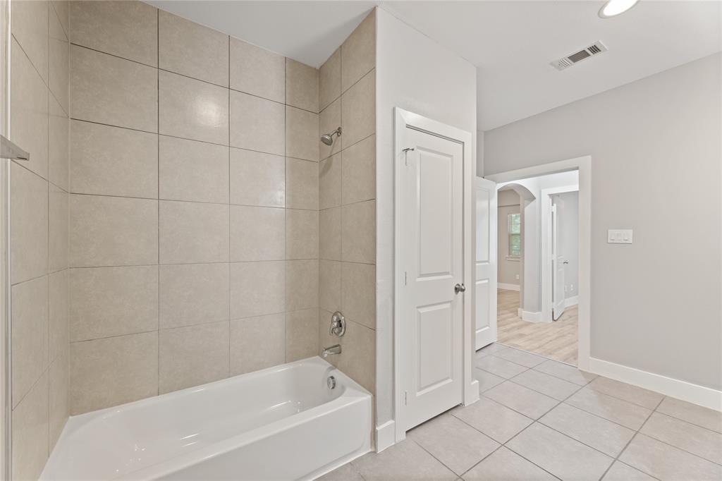 13609 Pinnacle Circle West, Unit 1102 Fort Worth, TX 76040 - Photo 14 of 21 a bathroom with a bathtub and shower