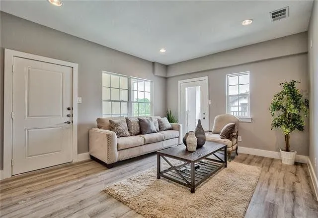 a living room with furniture and wooden floor