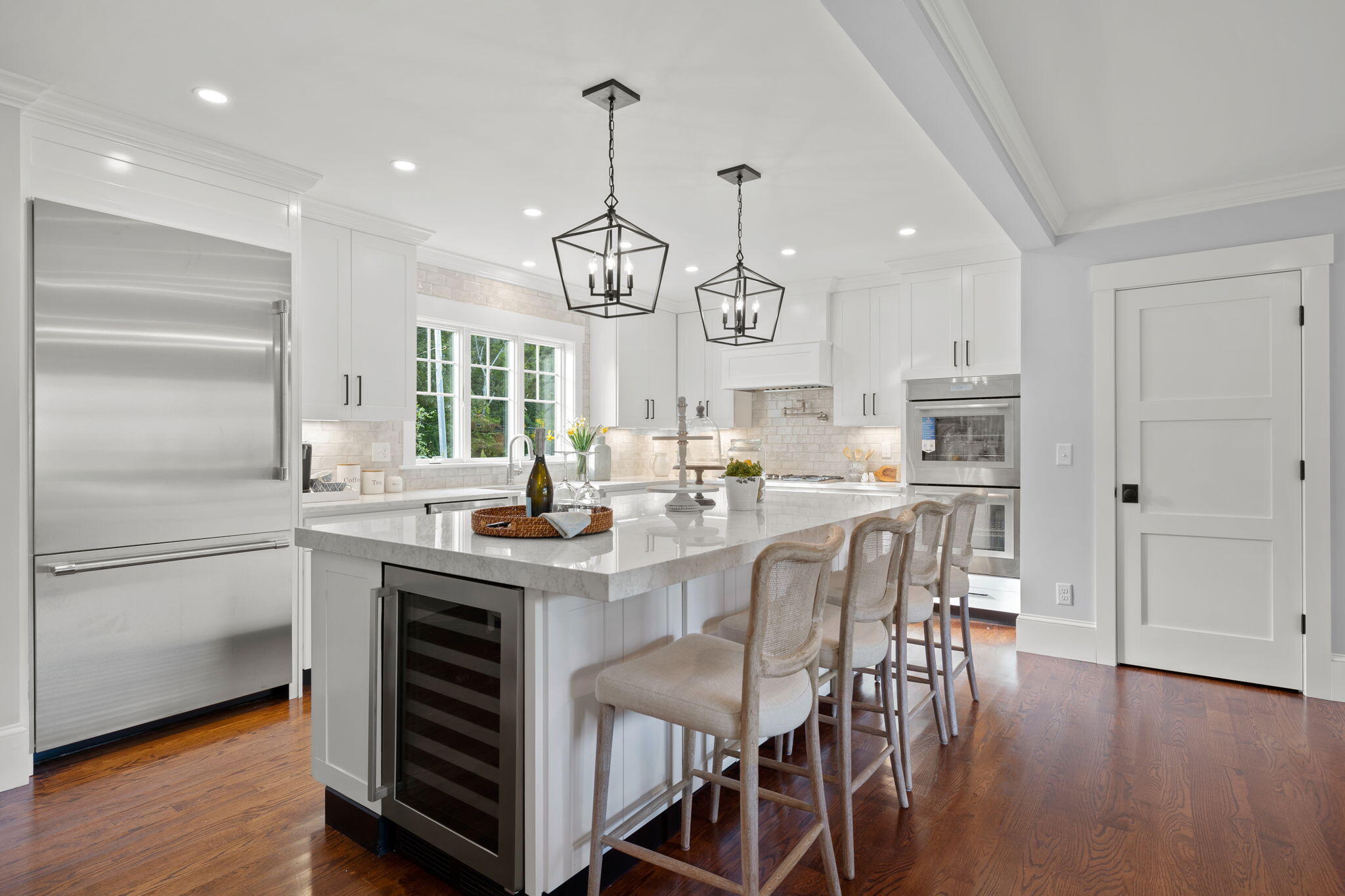 76 Old Mill Road Osterville, MA 02655 - Photo 19 of 45 a kitchen with stainless steel appliances granite countertop a table chairs and wooden floor