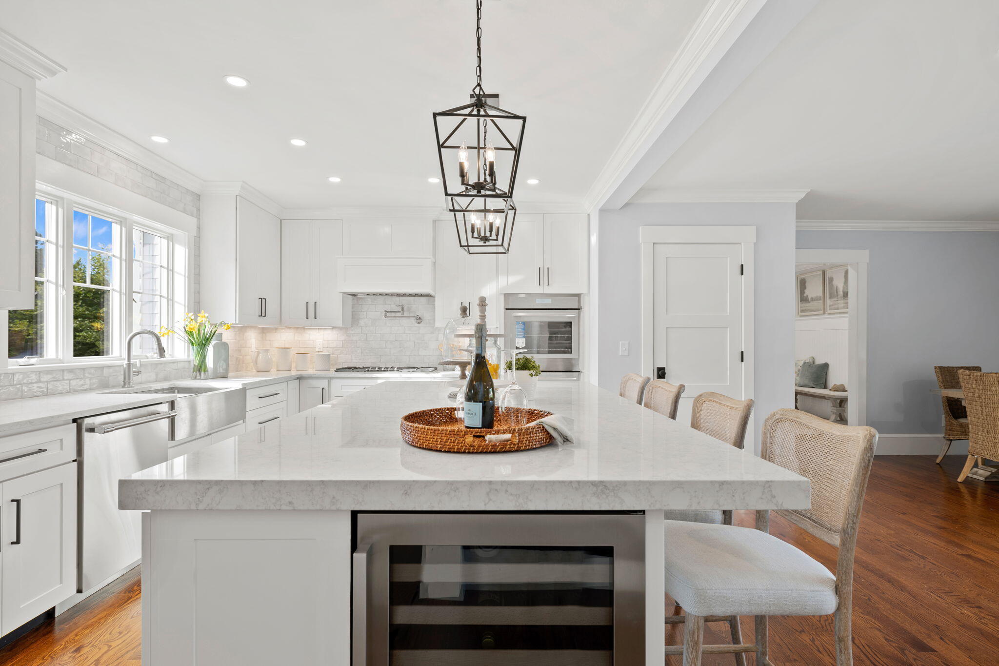 76 Old Mill Road Osterville, MA 02655 - Photo 20 of 45 a kitchen with a dining table chairs and white cabinets