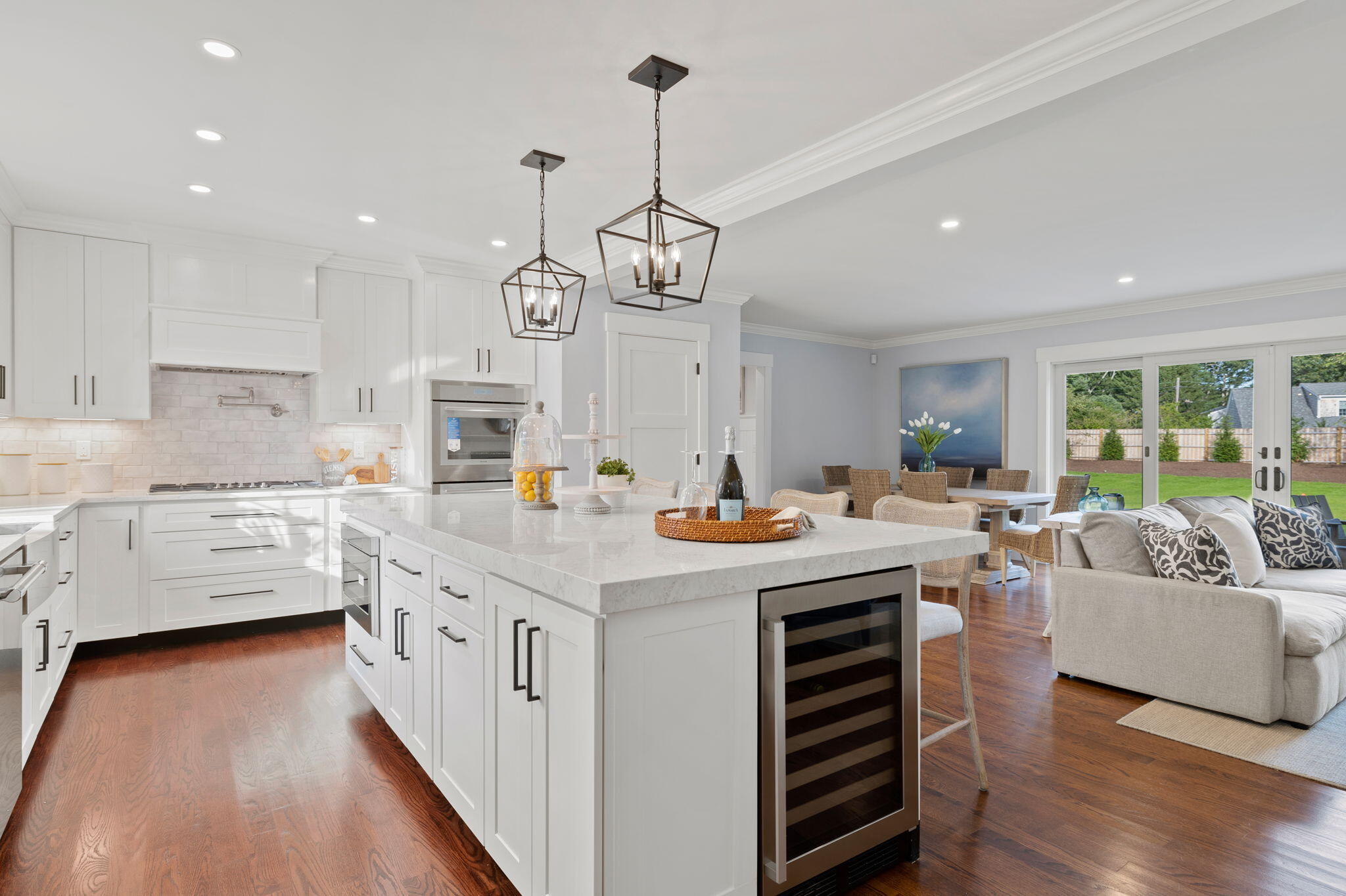 76 Old Mill Road Osterville, MA 02655 - Photo 21 of 45 a kitchen that has a lot of white cabinets stainless steel appliances and wooden floor