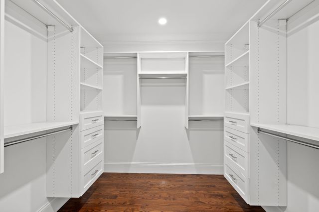 a view of walk in closet with empty racks