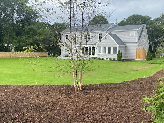 76 Old Mill Road Osterville, MA 02655 - Photo 5 of 45 a front view of a house with a garden and yard