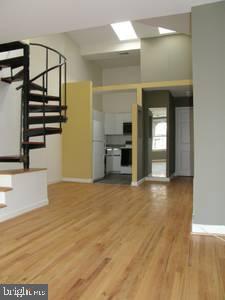 1856 Kalorama Road Northwest, Unit 5 Washington, DC 20009 - Photo 3 of 4 wooden floor in an empty room with a window