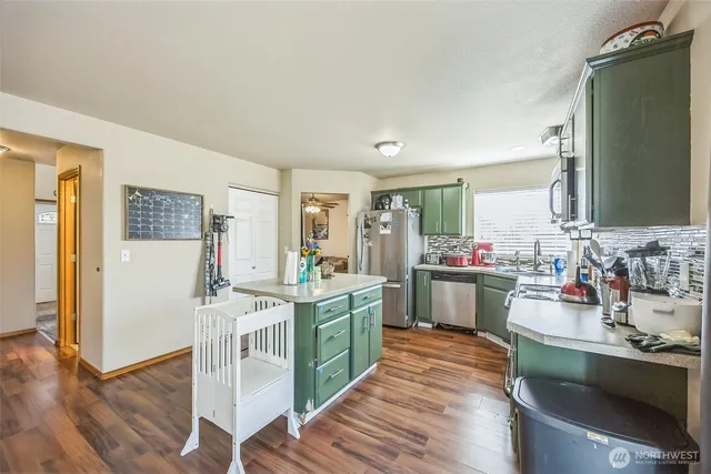 a kitchen with a sink cabinets and wooden floor