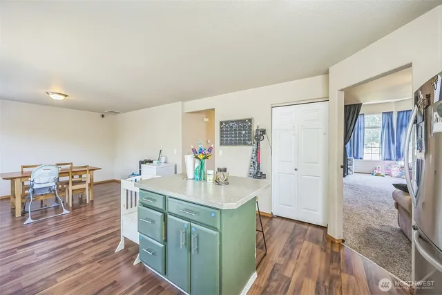 a kitchen with kitchen island cabinets and wooden floor
