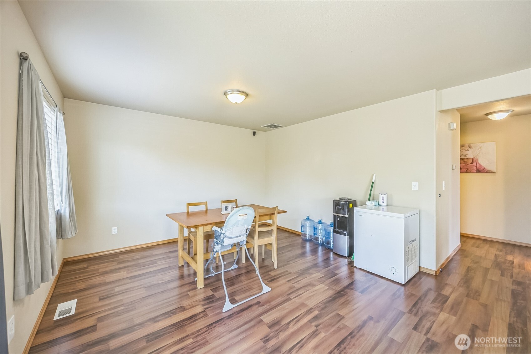 201 3rd Street Northeast Yelm, WA 98597 - Photo 16 of 30 a view of a dining room with furniture and wooden floor