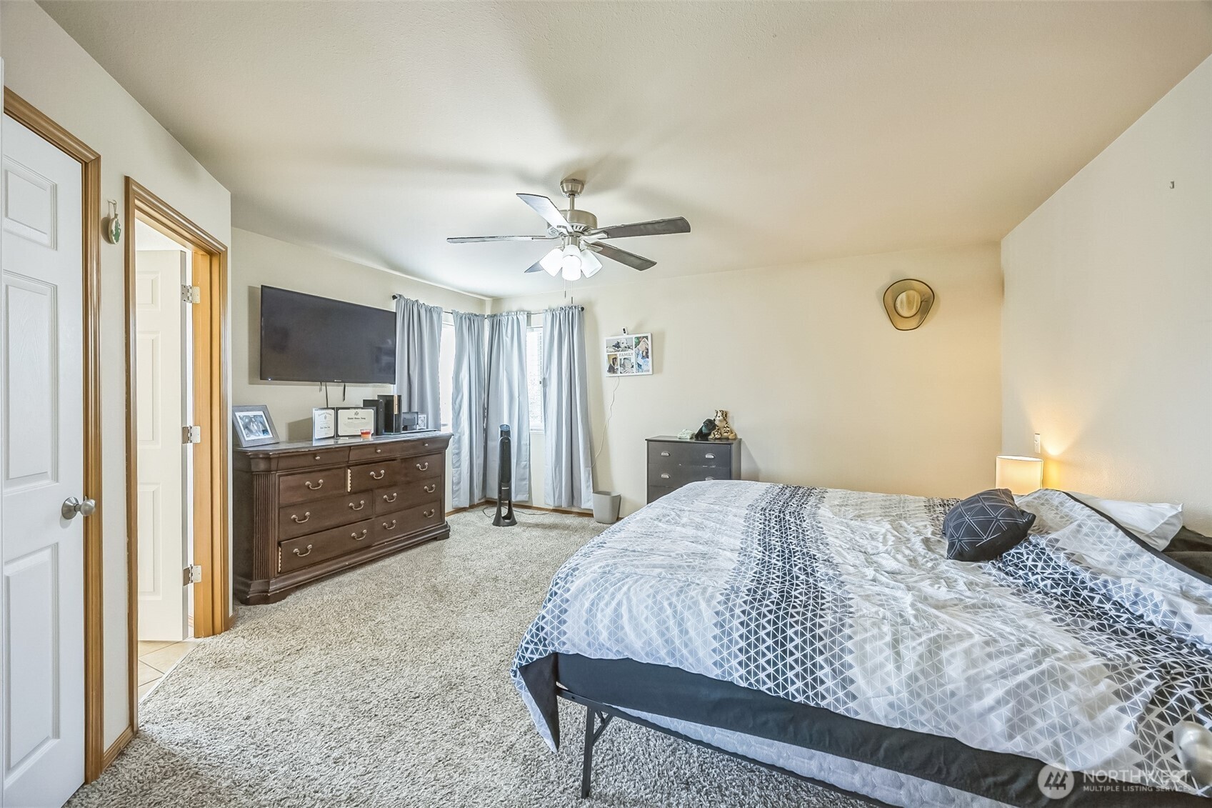 201 3rd Street Northeast Yelm, WA 98597 - Photo 18 of 30 a bedroom with a bed a dresser and a flat screen tv