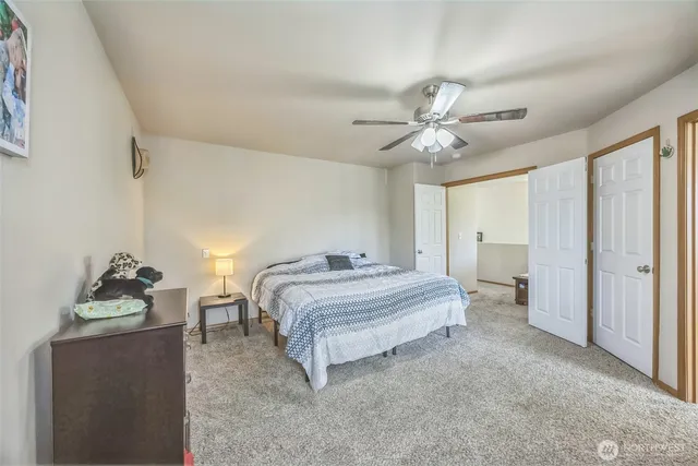 a spacious bedroom with a bed and a chandelier