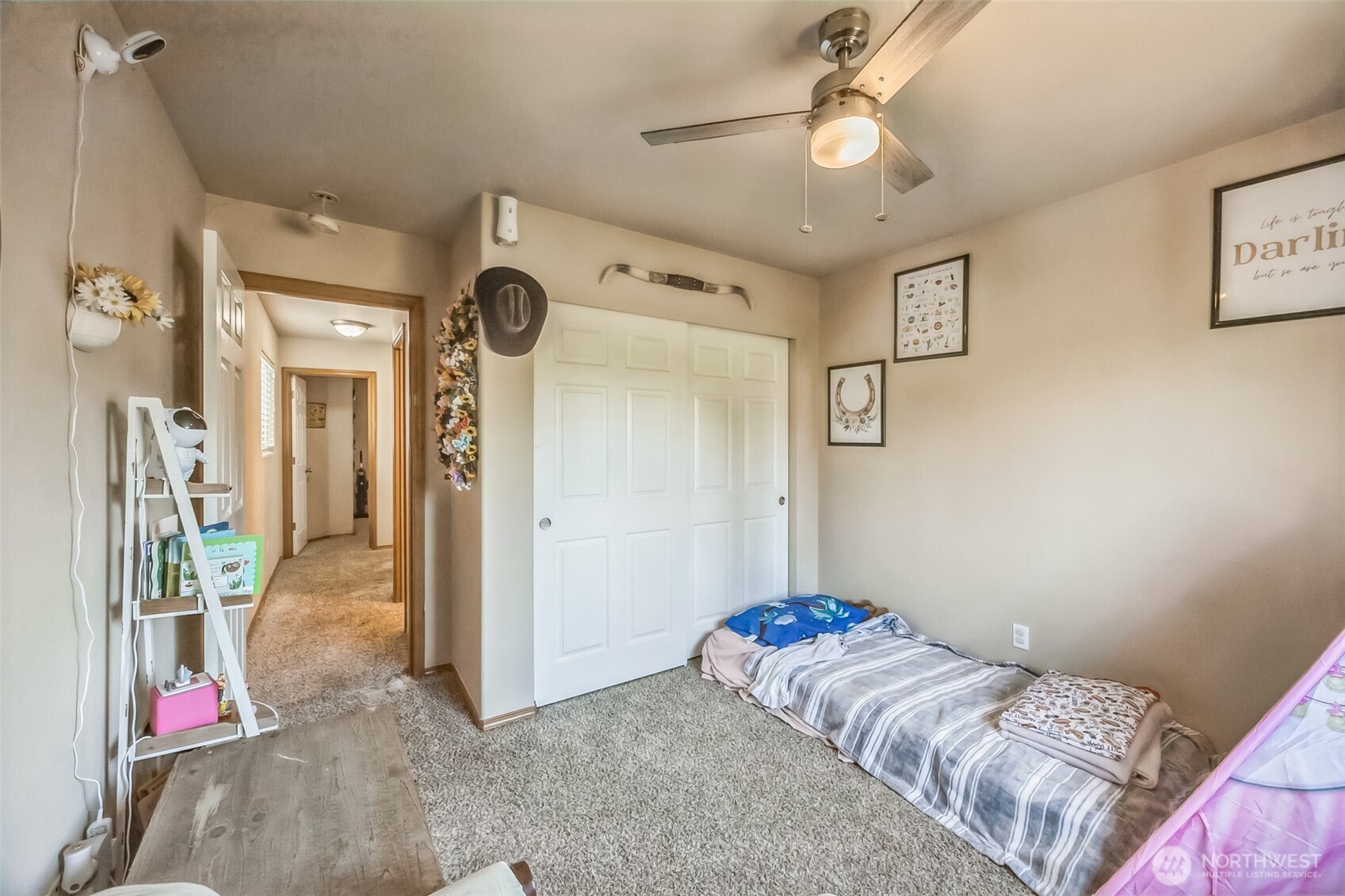 201 3rd Street Northeast Yelm, WA 98597 - Photo 24 of 30 a bedroom with bed and a chandelier