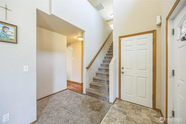 a view of entryway with wooden floor and stairs