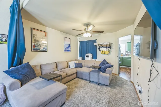 a living room with furniture and a chandelier