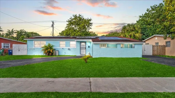 a view of house with a yard