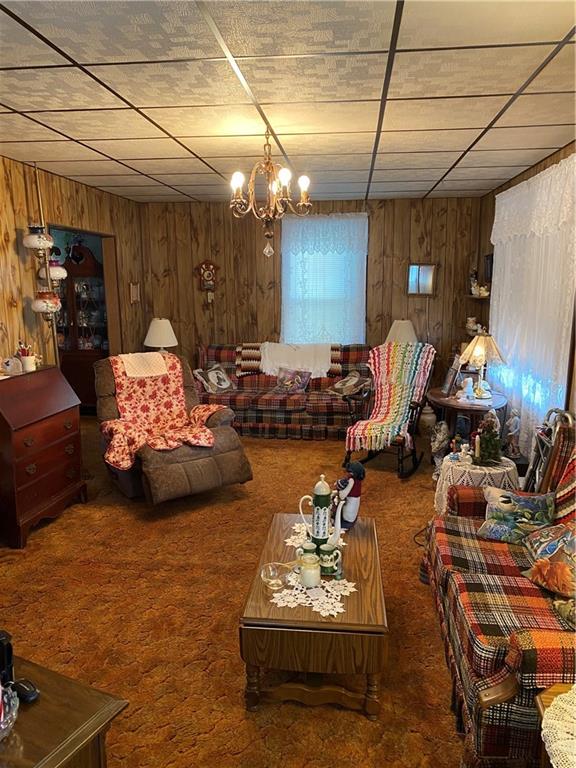 906 Maple Street Ruffs Dale, PA 15679 - Photo 8 of 13 a bedroom with furniture and a chandelier