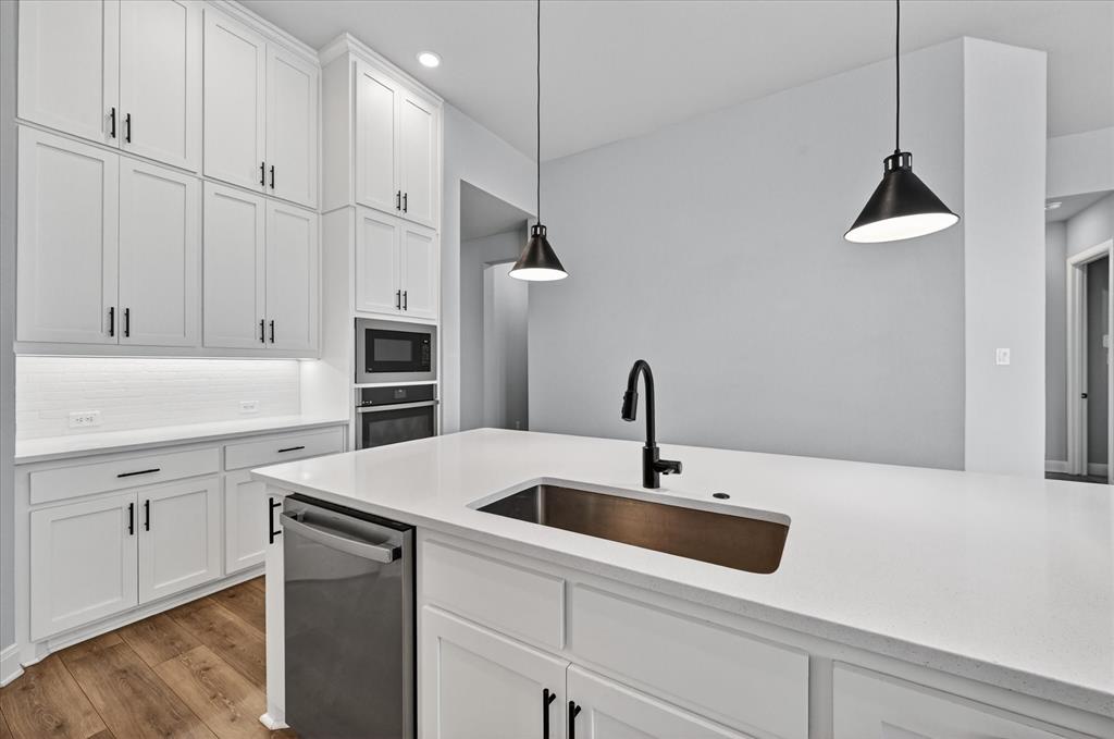 2237 Pika Road Northlake, TX 76247 - Photo 12 of 37 Spacious kitchen featuring an expansive island with an undermount sink and a matte black faucet