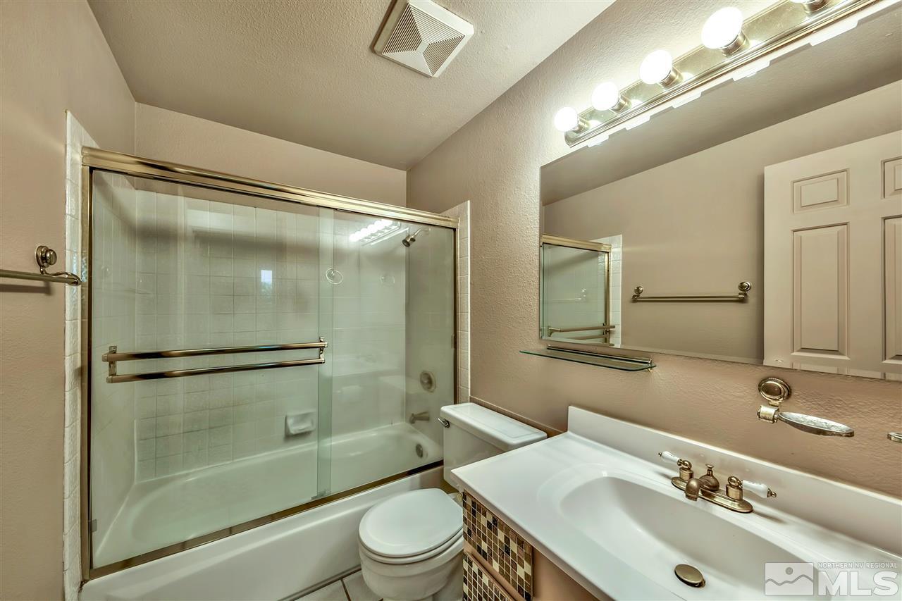 6640 Lotus Street Reno, NV 89506 - Photo 17 of 20 a bathroom with a sink mirror toilet and shower