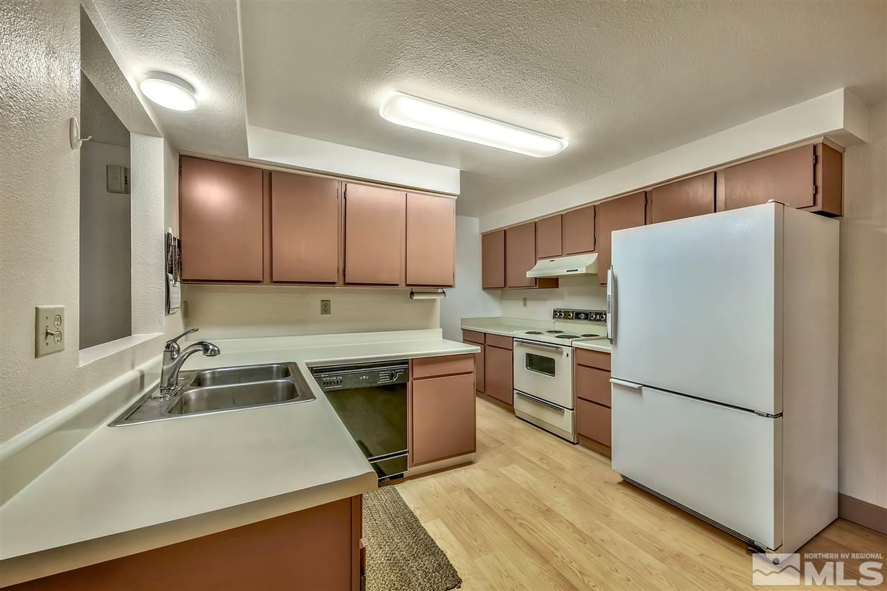6640 Lotus Street Reno, NV 89506 - Photo 9 of 20 a kitchen with a refrigerator sink and stove