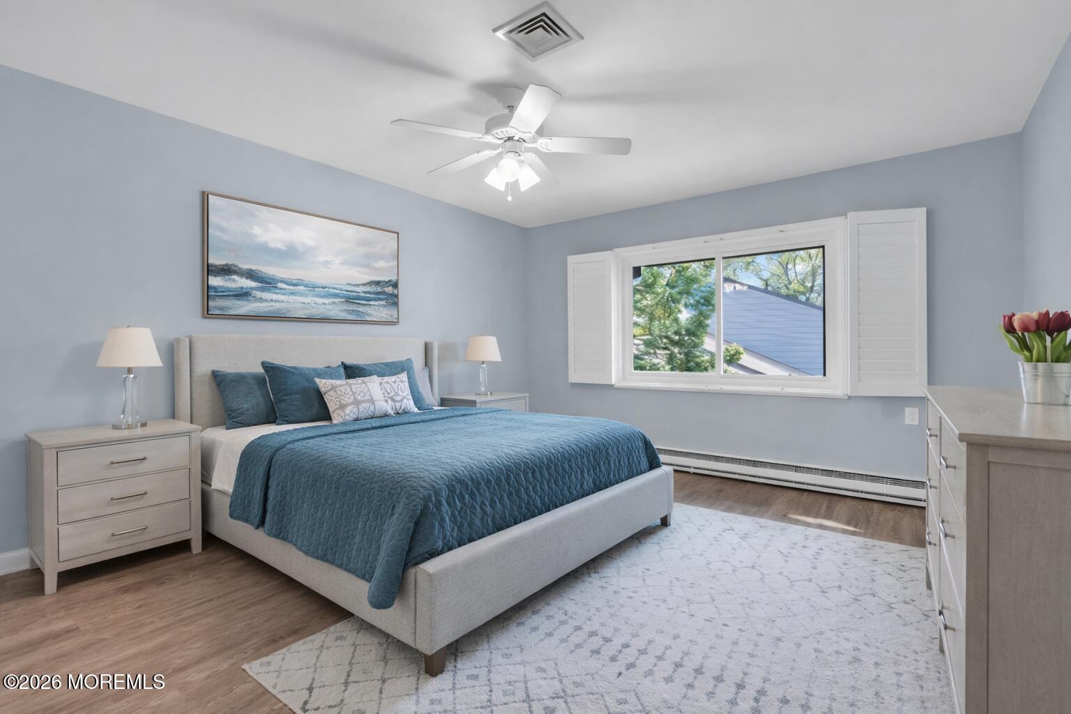 22 Claremont Court Red Bank, NJ 07701 - Photo 12 of 28 a bedroom with a large bed and a chandelier