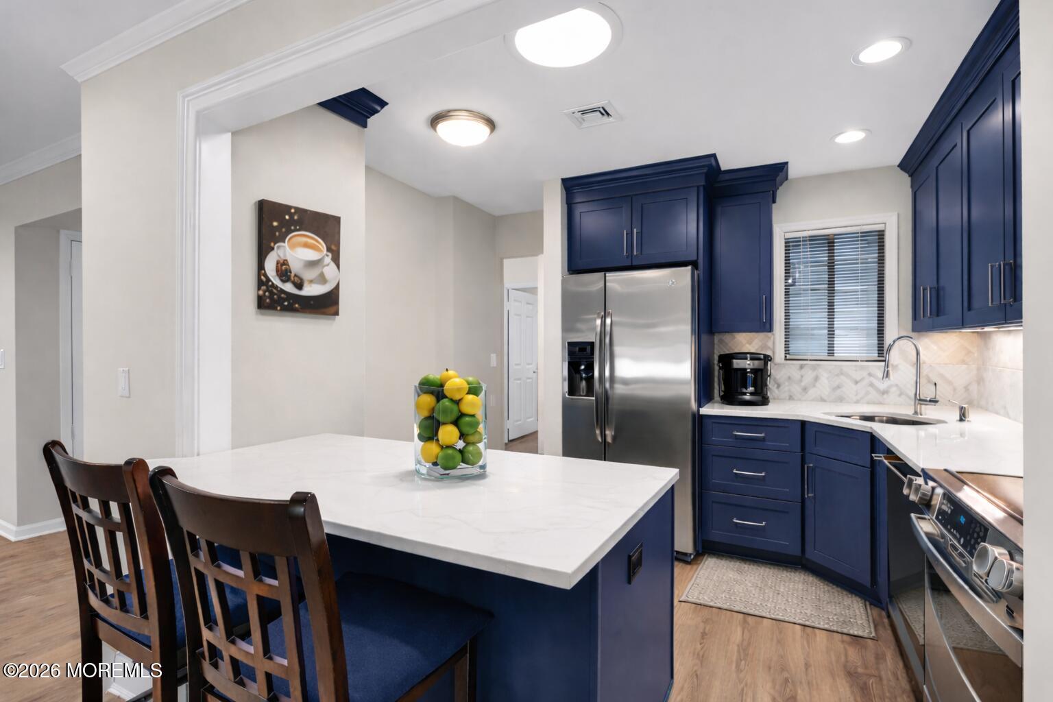 22 Claremont Court Red Bank, NJ 07701 - Photo 4 of 28 a kitchen with a table chairs and refrigerator