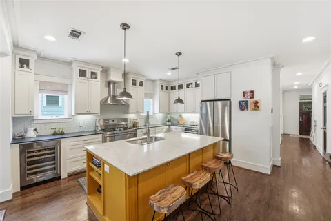 a kitchen with stainless steel appliances granite countertop a sink stove and refrigerator
