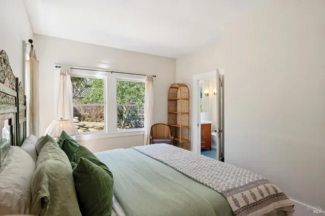 a bedroom with a bed and a chair