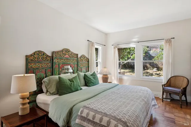 a bedroom with two beds and a night stand