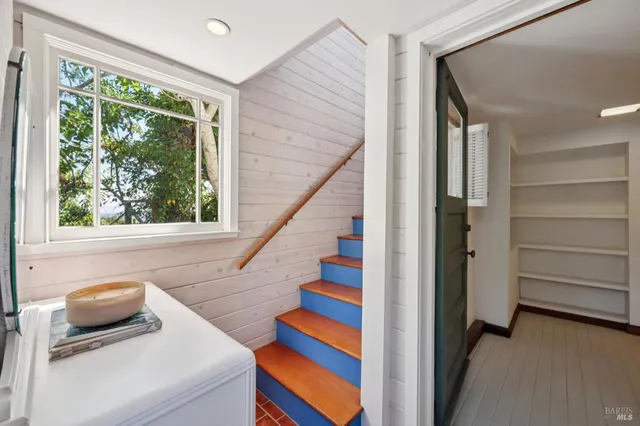 a bedroom with two beds and a window