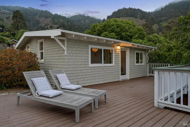 a view of a balcony with wooden floor and fence