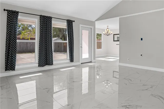 a view of a hallway with wooden floor and a bathroom