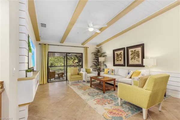 a living room with furniture and a floor to ceiling window
