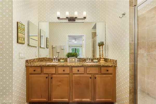 a bathroom with a sink vanity and mirror