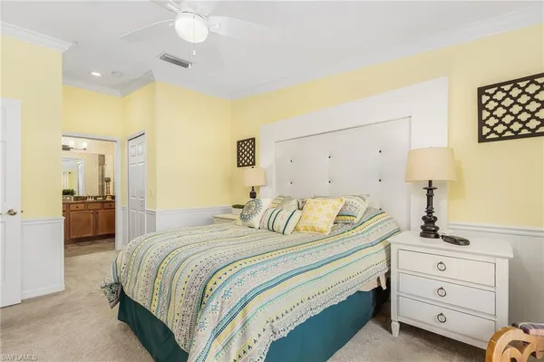 a bedroom with a bed and a night stand