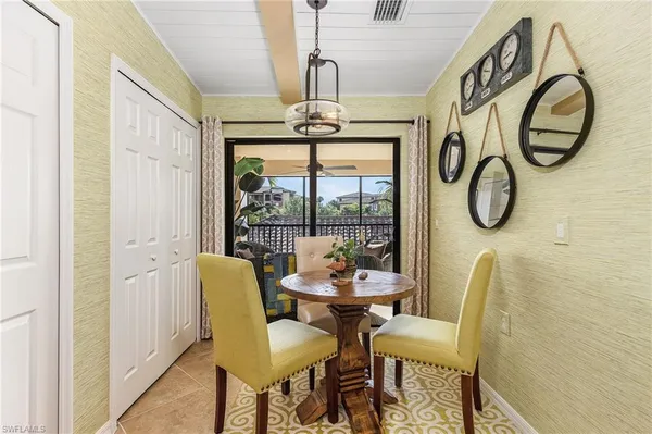 a dining room with furniture a chandelier and wooden floor