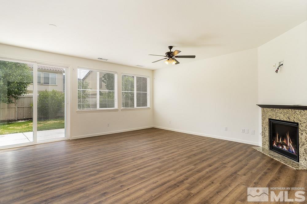 10872 Pebble Hill Drive Reno, NV 89521 - Photo 3 of 23 wooden floor in an empty room with a window
