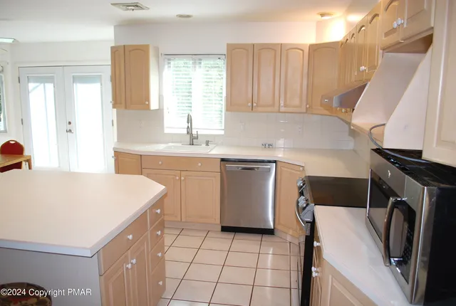 a view of an empty room with a fireplace and a window