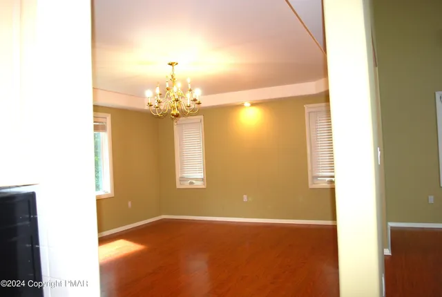 a spacious bathroom with a granite countertop sink and a mirror