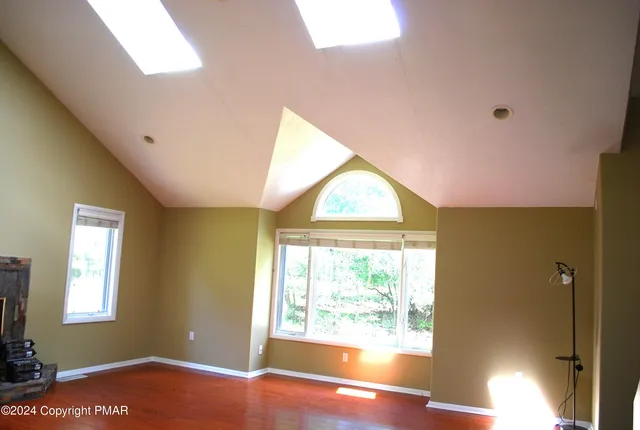 an empty room with a window and a mirror