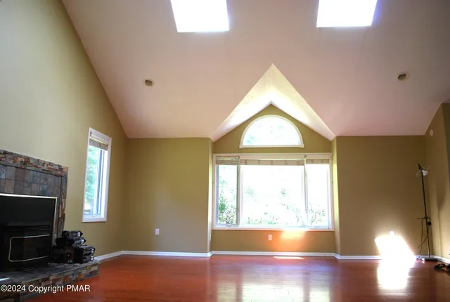 a view of an empty room with a window and a potted plant