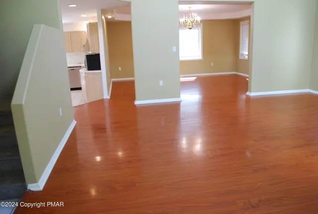 a view of an empty room with a fireplace and a window