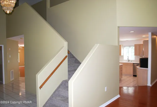 a view of an empty room with window and closet area
