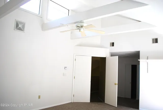 a kitchen with granite countertop a refrigerator and a stove top oven