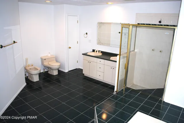 a front view of a house with a yard garage and tree