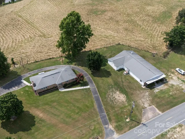 an aerial view of house with yard swimming pool and outdoor seating