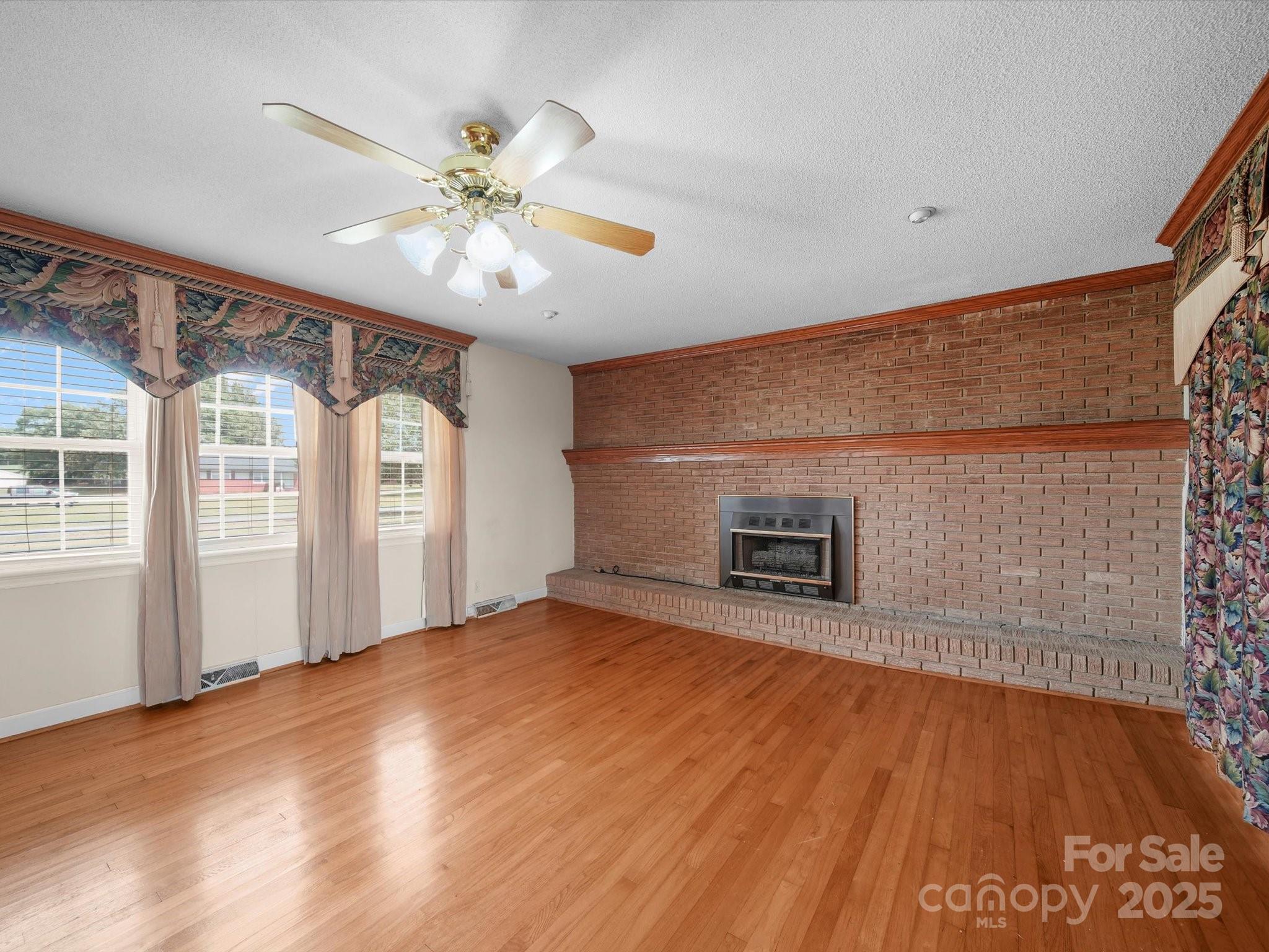 1497 White Store Road Pageland, SC 29728 - Photo 11 of 43 a view of an empty room with a window and wooden floor