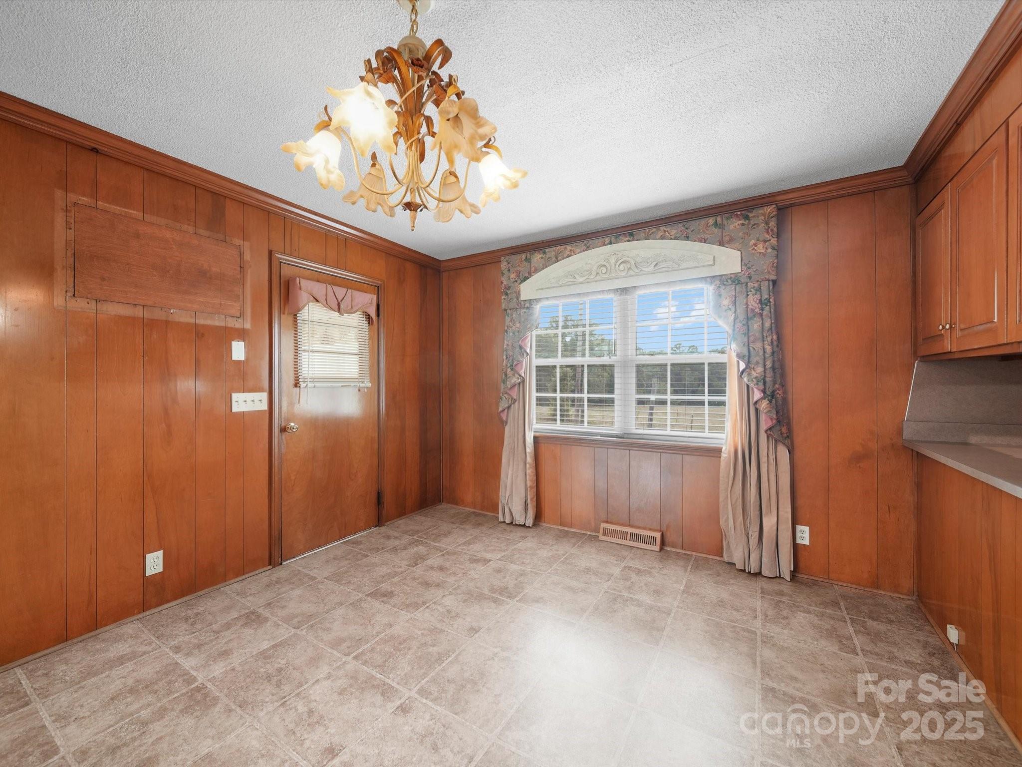 1497 White Store Road Pageland, SC 29728 - Photo 18 of 43 an empty room with chandelier fan and windows